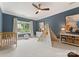 Blue bedroom with a crib, teepee, and a ceiling fan at 901 Hartford Ave, Charlotte, NC 28209