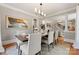 Dining room with a dark wood table, seating for six, and modern lighting at 901 Hartford Ave, Charlotte, NC 28209