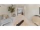 Hallway with hardwood floors, neutral decor, seating, a view to the other side of the home, and a potted plant at 901 Hartford Ave, Charlotte, NC 28209