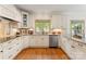 Bright U-shaped kitchen features granite countertops, tile backsplash, and stainless steel appliances at 901 Hartford Ave, Charlotte, NC 28209