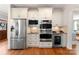 A modern kitchen with stainless steel appliances and custom cabinetry at 901 Hartford Ave, Charlotte, NC 28209