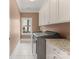 Functional laundry room with modern appliances, granite countertops, and ample cabinet space at 901 Hartford Ave, Charlotte, NC 28209