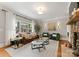 Elegant living room with stone fireplace, large windows, and comfortable seating at 901 Hartford Ave, Charlotte, NC 28209