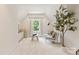 Bright sitting room featuring neutral decor, a window with curtains, and a plant, creating a peaceful and serene atmosphere at 901 Hartford Ave, Charlotte, NC 28209