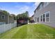 Well-maintained backyard with green lawn, deck, and privacy fence at 10012 Michael Crossing Dr, Charlotte, NC 28213