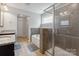 Bright bathroom featuring tiled shower, soaking tub, vanity, and tile flooring at 10012 Michael Crossing Dr, Charlotte, NC 28213