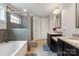 Luxurious primary bathroom with double vanity, soaking tub, and a glass-enclosed shower at 10012 Michael Crossing Dr, Charlotte, NC 28213