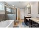 Elegant bathroom featuring double vanity, soaking tub and shower with stylish tile surround at 10012 Michael Crossing Dr, Charlotte, NC 28213