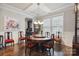 Elegant dining room with round table, decorative chairs, and stylish chandelier at 10012 Michael Crossing Dr, Charlotte, NC 28213