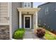 Home's front entrance features a covered porch, neatly kept landscaping and the house number at 10012 Michael Crossing Dr, Charlotte, NC 28213