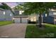 Attractive two-story home with a two-car garage and landscaped yard; virtually staged to show potential at 10012 Michael Crossing Dr, Charlotte, NC 28213