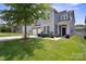 Inviting two-story home with a two-car garage, stone accents, and manicured lawn at 10012 Michael Crossing Dr, Charlotte, NC 28213