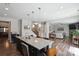 Stylish kitchen with a granite island, stainless steel sink, and dark wood floors, perfect for entertaining at 10012 Michael Crossing Dr, Charlotte, NC 28213