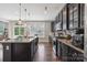 Modern kitchen with black cabinets, granite countertops, and stainless steel appliances offers style and function at 10012 Michael Crossing Dr, Charlotte, NC 28213