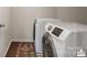 Bright laundry room featuring modern, front-load washer and dryer with a decorative rug at 10012 Michael Crossing Dr, Charlotte, NC 28213