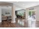 Bright living room features a fireplace, access to the deck, and sleek, dark hardwood floors at 10012 Michael Crossing Dr, Charlotte, NC 28213