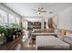 Bright, open-concept living room with dark floors, ceiling fan, and natural light flowing to the kitchen at 10012 Michael Crossing Dr, Charlotte, NC 28213