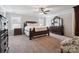 Spacious primary bedroom featuring tray ceilings, a ceiling fan, and generous natural light at 10012 Michael Crossing Dr, Charlotte, NC 28213