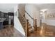 View of the stairway featuring wood banisters, carpeted stairs, and hardwood floors in the entryway at 10012 Michael Crossing Dr, Charlotte, NC 28213