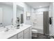 Bright bathroom featuring double sinks, a large mirror, and a tub-shower combination at 10112 Florentine Ln, Charlotte, NC 28214