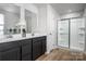 Bright bathroom featuring double vanity, framed mirror and glass shower, promoting a spa-like experience at 10112 Florentine Ln, Charlotte, NC 28214