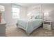 Serene bedroom features a soft color palette, window with natural light, creating a calming space at 10112 Florentine Ln, Charlotte, NC 28214