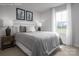 Light bedroom with queen-sized bed, framed art and natural lighting offers a relaxing retreat at 10112 Florentine Ln, Charlotte, NC 28214