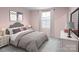 Charming bedroom featuring a soft color palette, cozy bedding, and stylish decor for a relaxing retreat at 10112 Florentine Ln, Charlotte, NC 28214