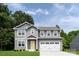 Charming two-story home featuring gray siding, a welcoming entrance, and a convenient two-car garage at 10112 Florentine Ln, Charlotte, NC 28214