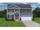 Attractive two-story home with gray siding, front door, well-manicured lawn and a convenient two-car garage at 10112 Florentine Ln, Charlotte, NC 28214