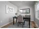 Cozy home office setup with a dark wood desk, comfortable chair, and elegant decor at 10112 Florentine Ln, Charlotte, NC 28214