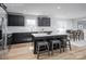 Modern kitchen featuring black cabinetry, stainless steel appliances, a kitchen island, and wood-look flooring at 10112 Florentine Ln, Charlotte, NC 28214