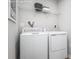 Efficient laundry room with modern washer, dryer, and overhead shelving, provides convenient storage at 10112 Florentine Ln, Charlotte, NC 28214