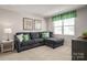 Comfortable living room with sectional sofa, natural light and decor, perfect for relaxation at 10112 Florentine Ln, Charlotte, NC 28214