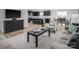 Open-concept living space with modern furnishings, hardwood floors, and a view into the kitchen and dining area at 10112 Florentine Ln, Charlotte, NC 28214