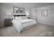 Comfortable main bedroom with neutral walls, carpet, and framed art provides a relaxing retreat at 10112 Florentine Ln, Charlotte, NC 28214