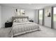 Serene main bedroom with a tufted headboard, decorative pillows, and bright natural lighting at 10112 Florentine Ln, Charlotte, NC 28214