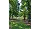 Expansive backyard with mature trees and lake views, perfect for outdoor enjoyment and relaxation at 10311 Windtree Ln, Charlotte, NC 28215