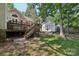 Backyard with deck and stairs leading to a charming shed with a ramp for storage at 10311 Windtree Ln, Charlotte, NC 28215