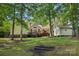View of the house's backyard, complete with wooden deck and storage building at 10311 Windtree Ln, Charlotte, NC 28215