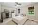 Bedroom featuring a bed, carpeted floors, neutral walls, and a window overlooking the backyard at 10311 Windtree Ln, Charlotte, NC 28215