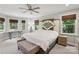 Spacious bedroom with a ceiling fan, lots of natural light, and a unique headboard at 10311 Windtree Ln, Charlotte, NC 28215