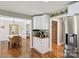 The dining room has wood floors and is open to the living room and kitchen at 10311 Windtree Ln, Charlotte, NC 28215