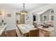 Open dining room features wood floors and is adjacent to the living room for easy access at 10311 Windtree Ln, Charlotte, NC 28215