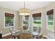 Breakfast nook with a glass table on a wine barrel and natural lighting at 10311 Windtree Ln, Charlotte, NC 28215