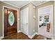 Warm entryway with hardwood floors and a decorative wood front door at 10311 Windtree Ln, Charlotte, NC 28215