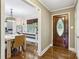Welcoming entryway featuring hardwood floors and a decorative oval glass front door at 10311 Windtree Ln, Charlotte, NC 28215