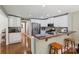 Bright kitchen with stainless steel appliances, breakfast bar, and view to the dining room at 10311 Windtree Ln, Charlotte, NC 28215