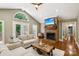 Bright living room featuring a brick fireplace, high ceilings, and French doors to the patio at 10311 Windtree Ln, Charlotte, NC 28215