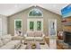 Bright living room with high ceilings, large windows, and a cozy seating area at 10311 Windtree Ln, Charlotte, NC 28215